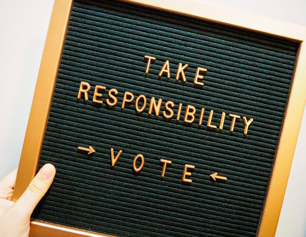 A sign that says Take Responsibility - Vote