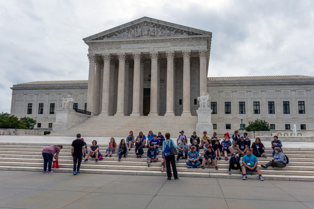 Tourists on the stairs of supreme court of the united states of America