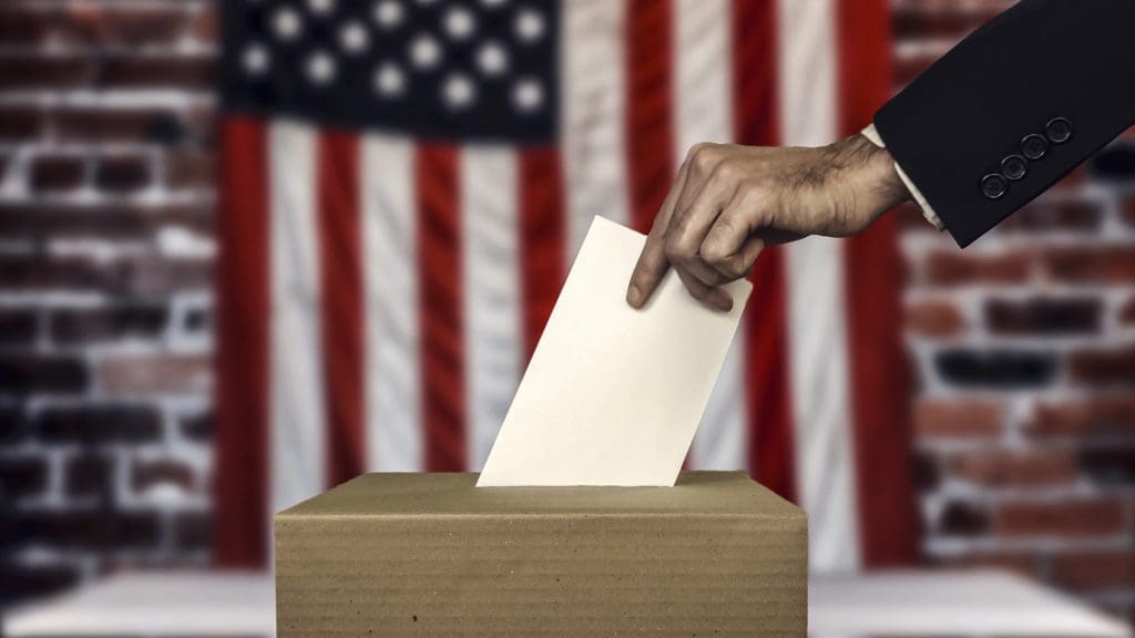 Every vote counts - man placing an envelope into a ballot box